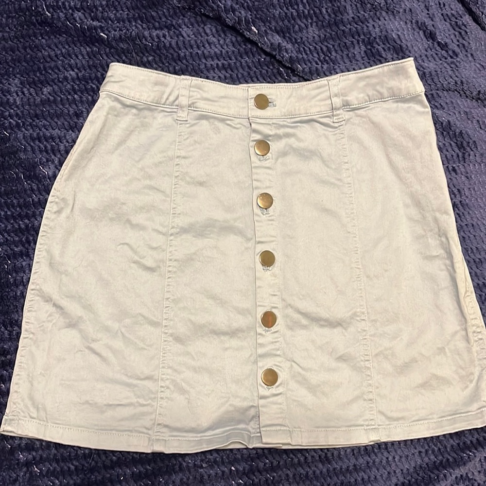 Blue mid-rise skirt with dark silver buttons.